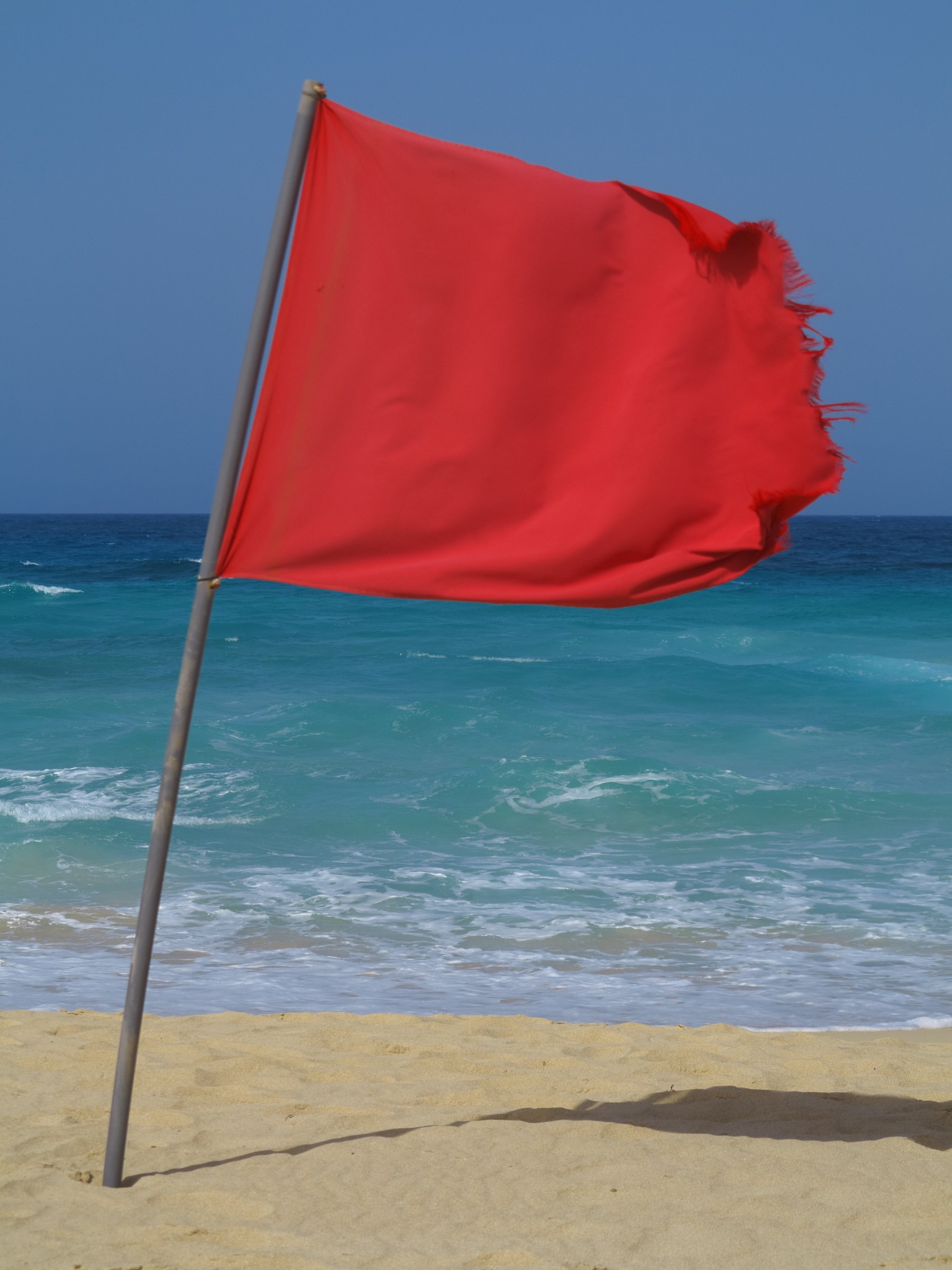 Red no-swimming flag at Grandes Playas in Corralejo, Fuerteventura